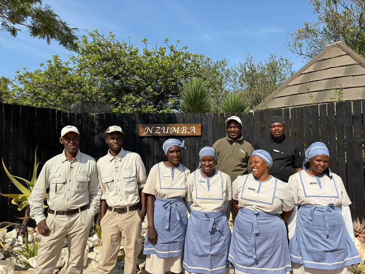 Nzumba staff serving dinner in the boma under the stars