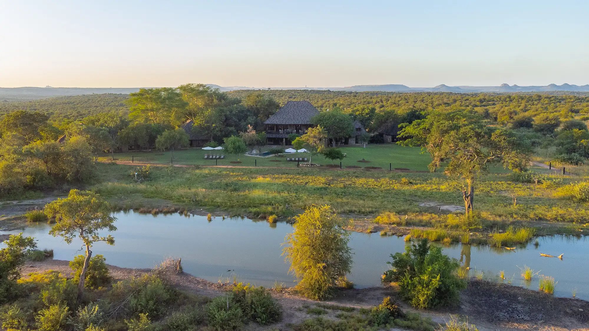 Aerial view of Nzumba Lodge nestled beside its waterhole in the Klaserie bushveld