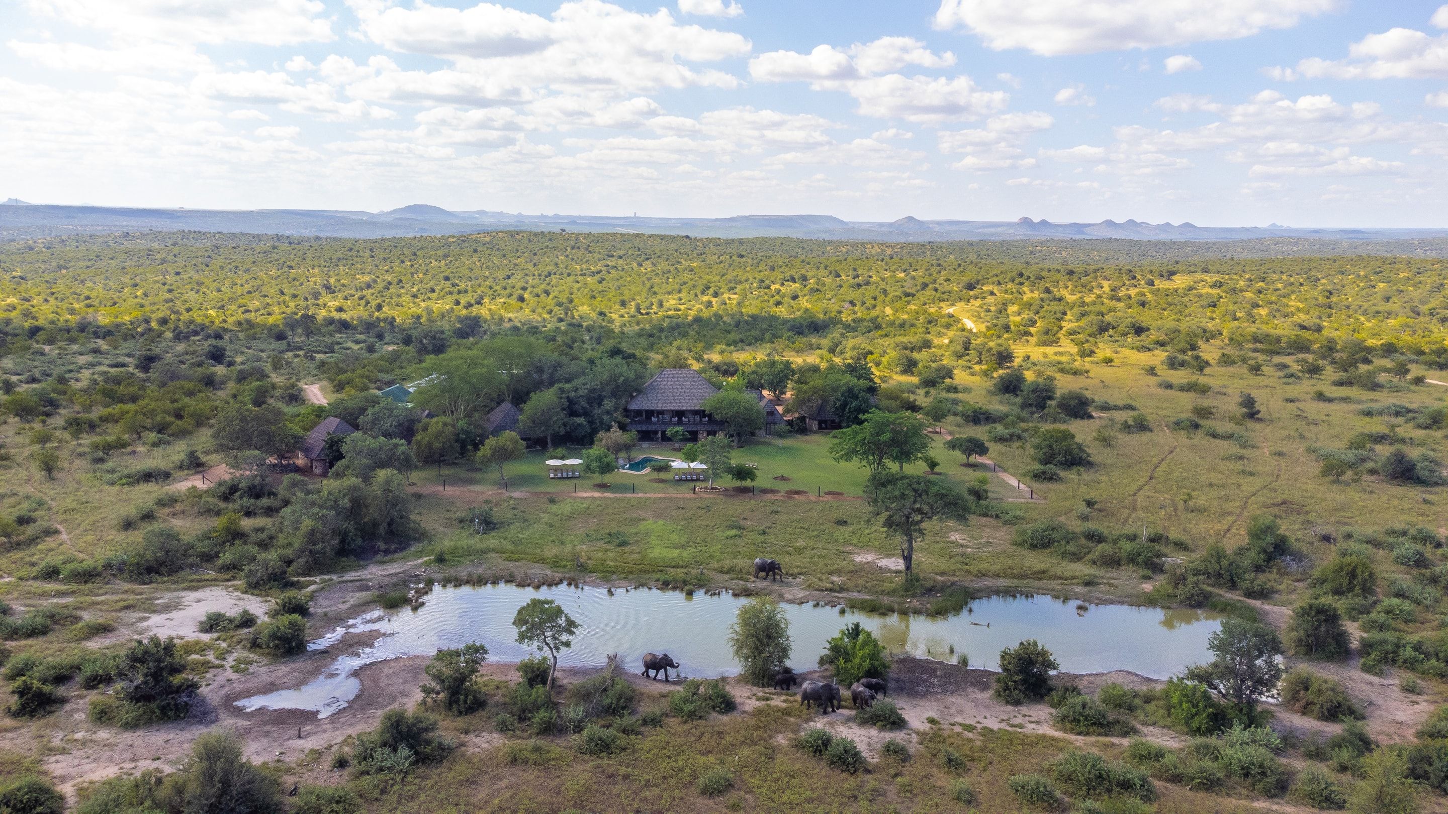 Aerial view of Nzumba Lodge nestled beside its waterhole in the Klaserie bushveld