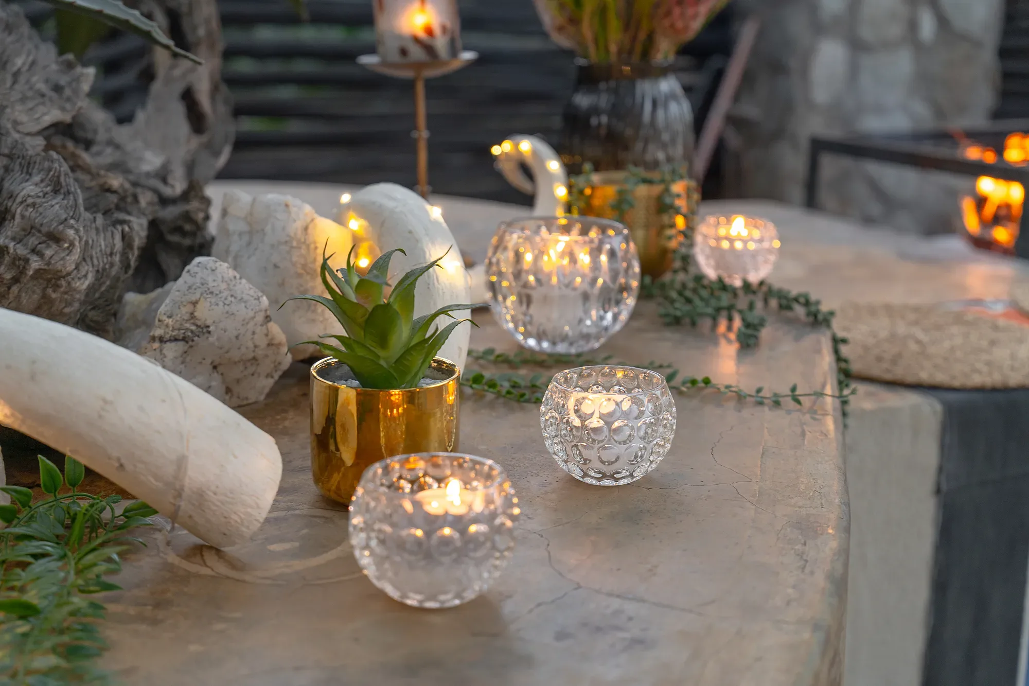 Close detail of a candlelit dining table setting at Nzumba Lodge