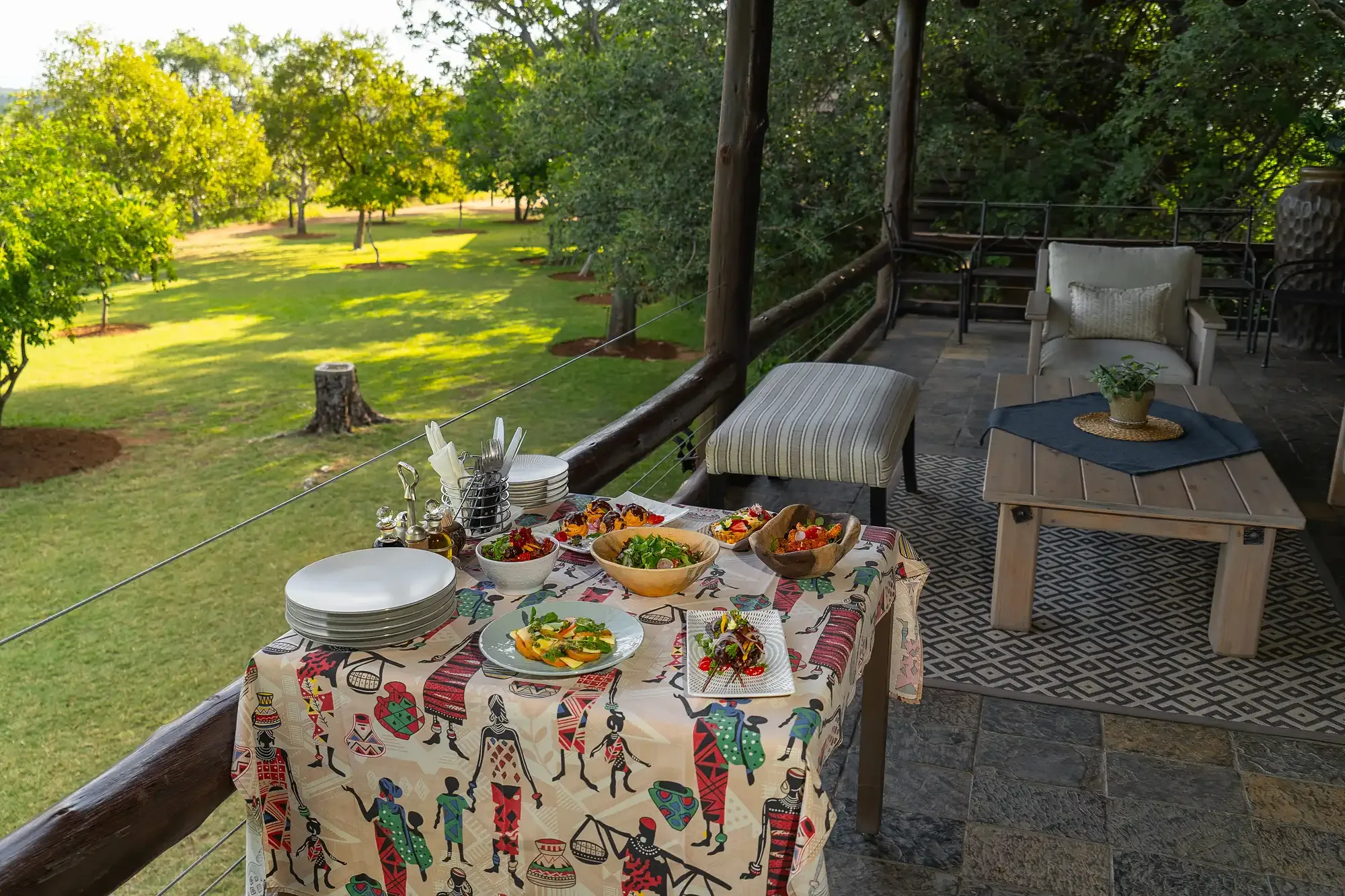 A dining table set on the deck at Nzumba Lodge overlooking the Klaserie bushveld