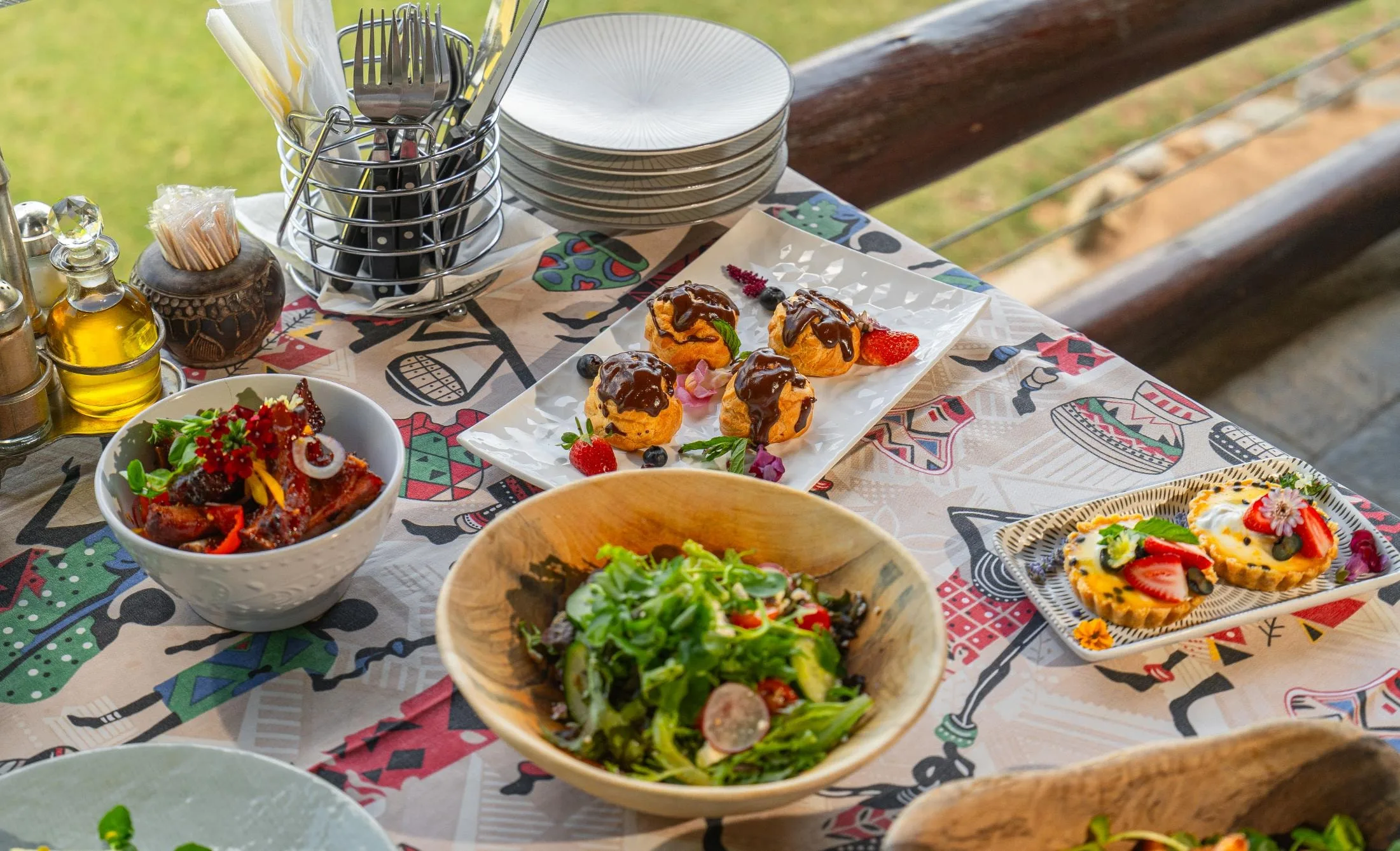 More than the traditional — a Nzumba high-tea spread laid out under the trees