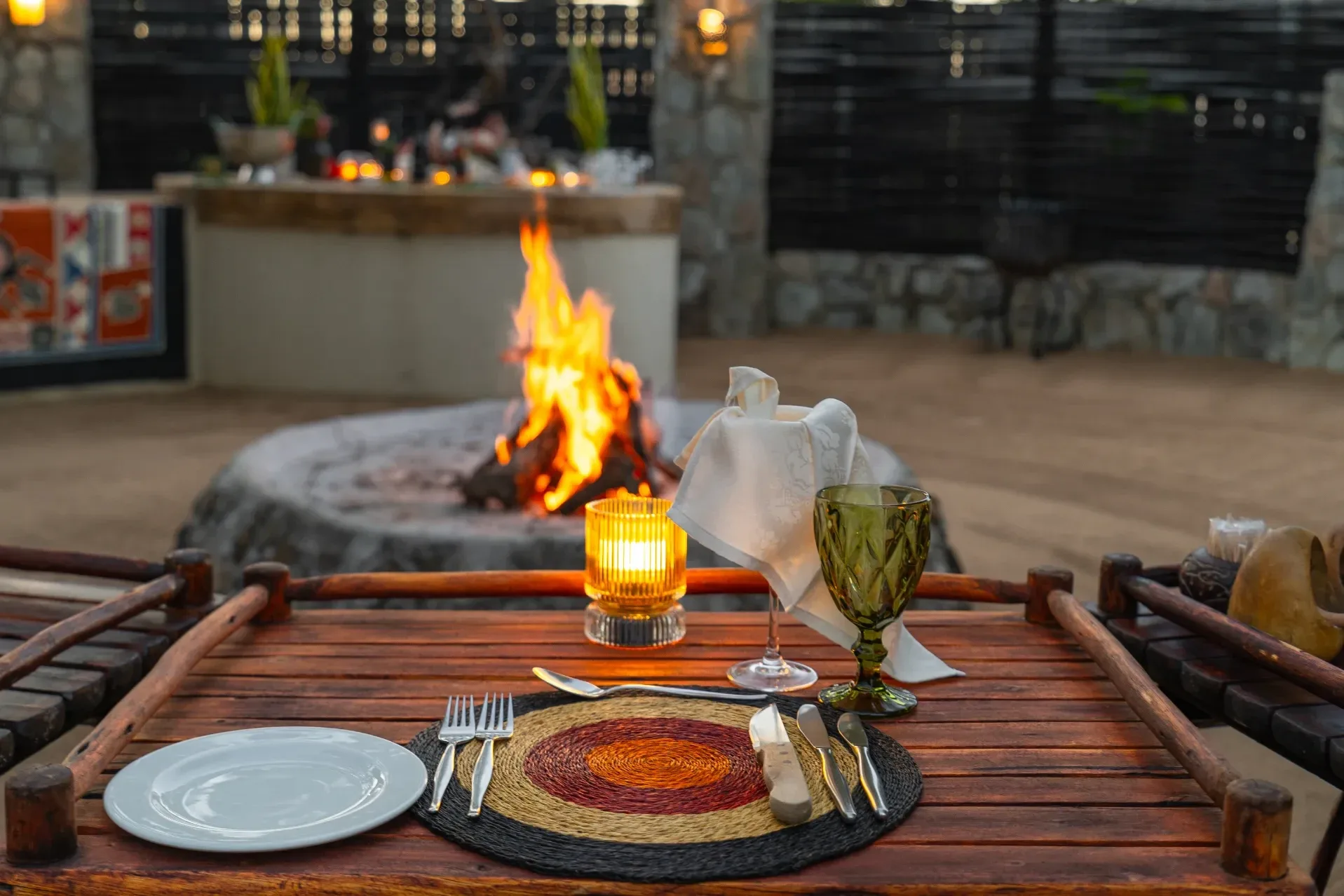 A Nzumba boma dinner setting under firelight