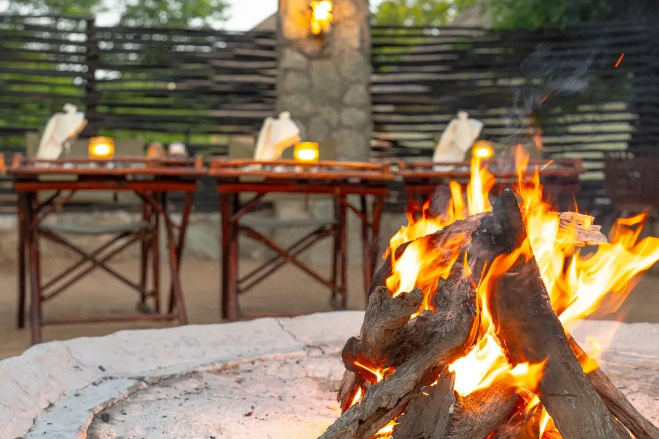 A Nzumba boma dinner spread — convivial and candlelit