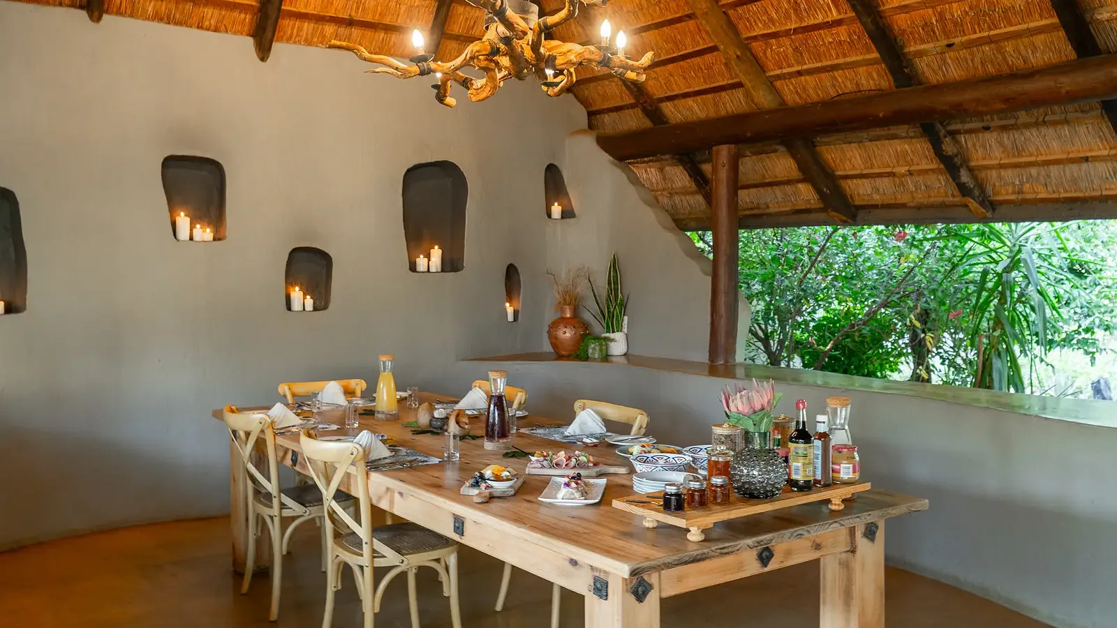 A Nzumba boma dinner spread — convivial and candlelit