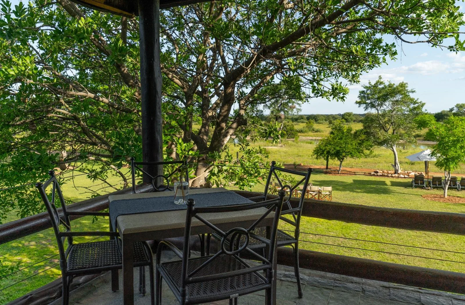 A shaded balcony table at Nzumba Lodge looking out over the Klaserie bushveld