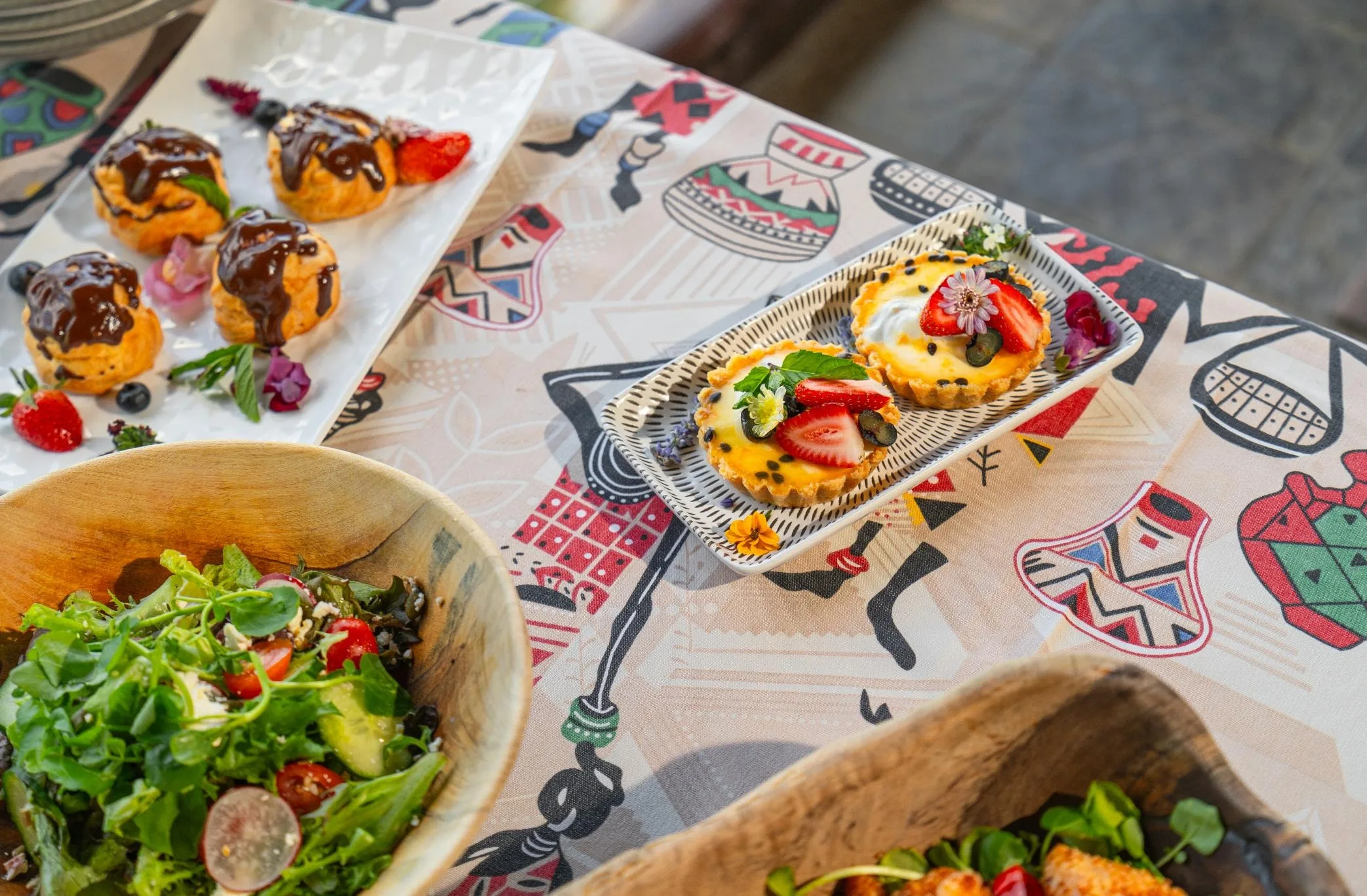 Nzumba Lodge high tea — sweet and savoury bites on a printed African cloth