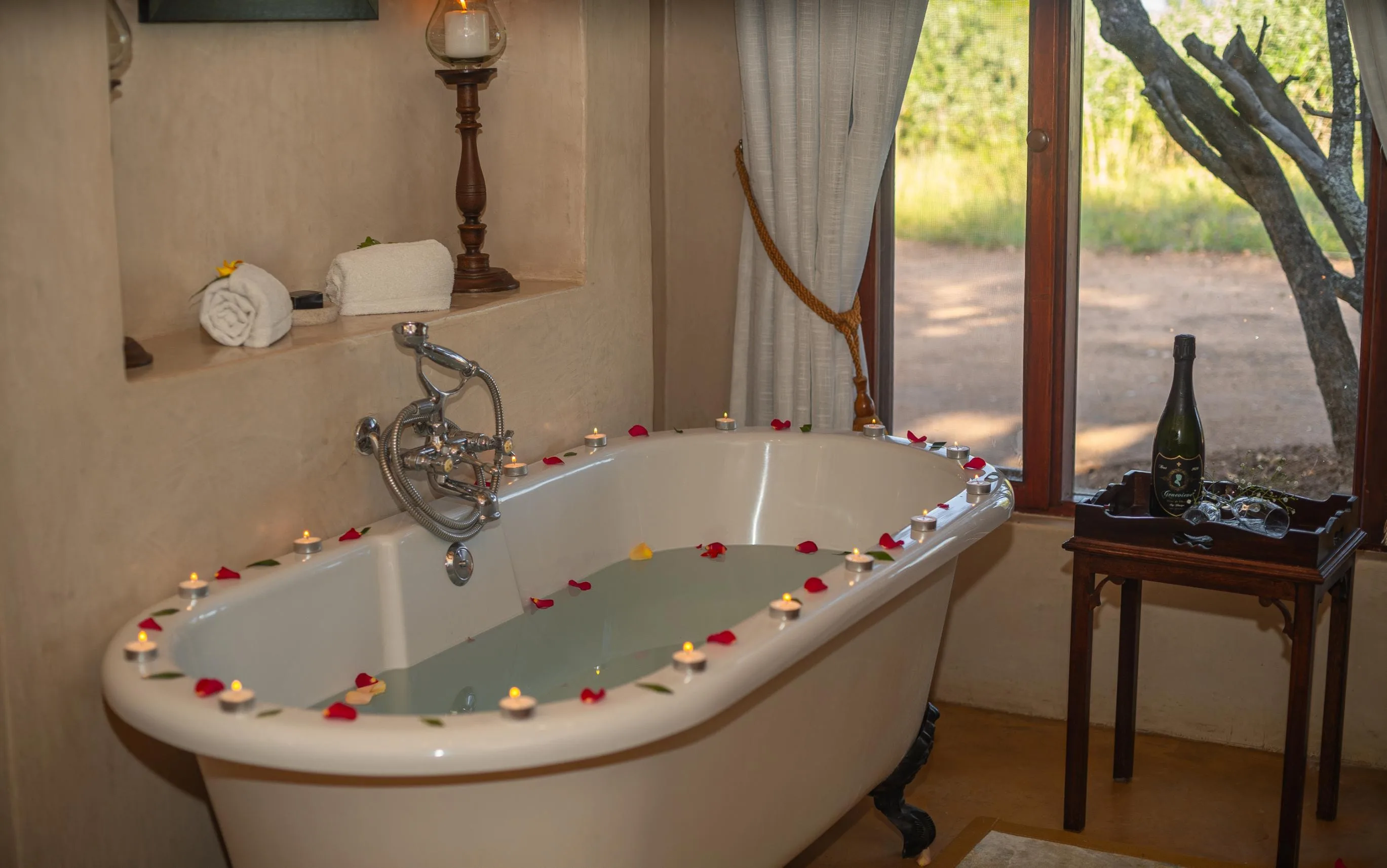 A romantic chalet turn-down at Nzumba Lodge with bathtub, candles and rose petals