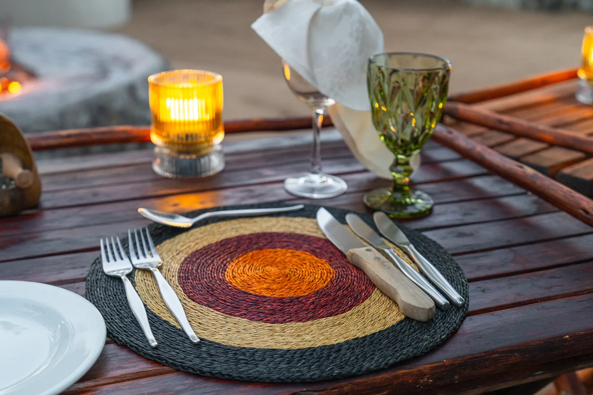 A private candlelit table set for two on a Nzumba Lodge deck