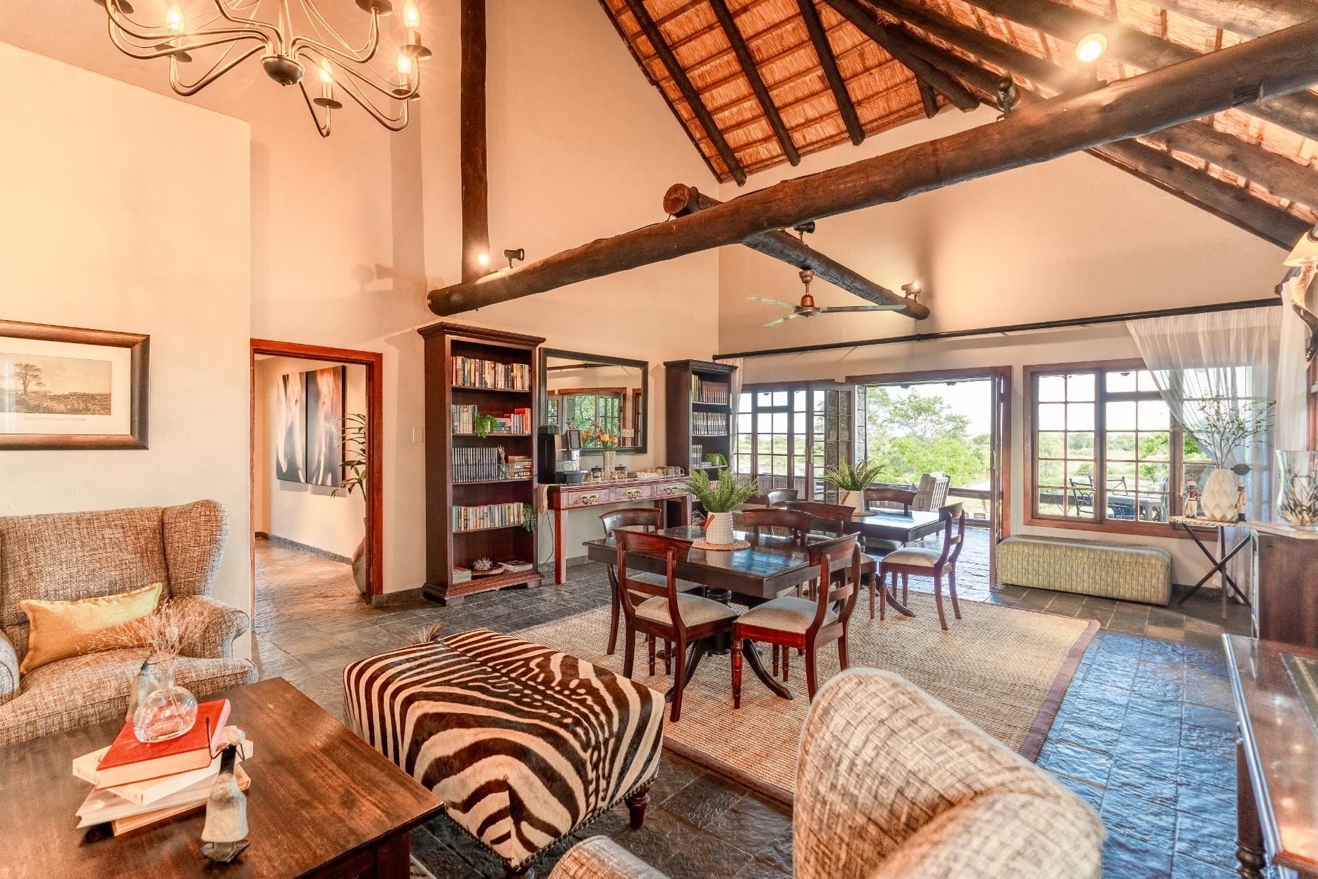 The main lodge gathering space at Nzumba, leather chairs and fireplace