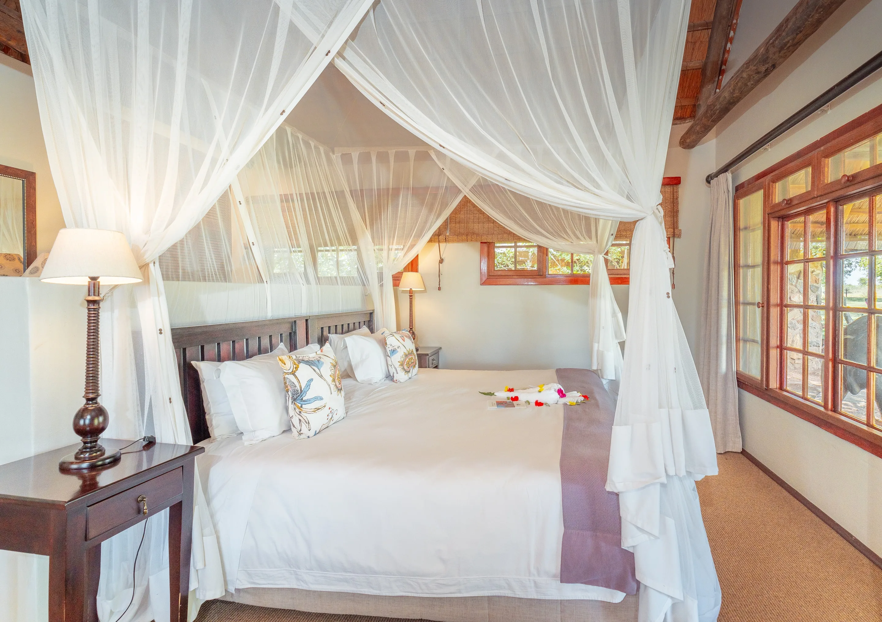 A Nzumba thatched chalet interior with warm timber and curated detail