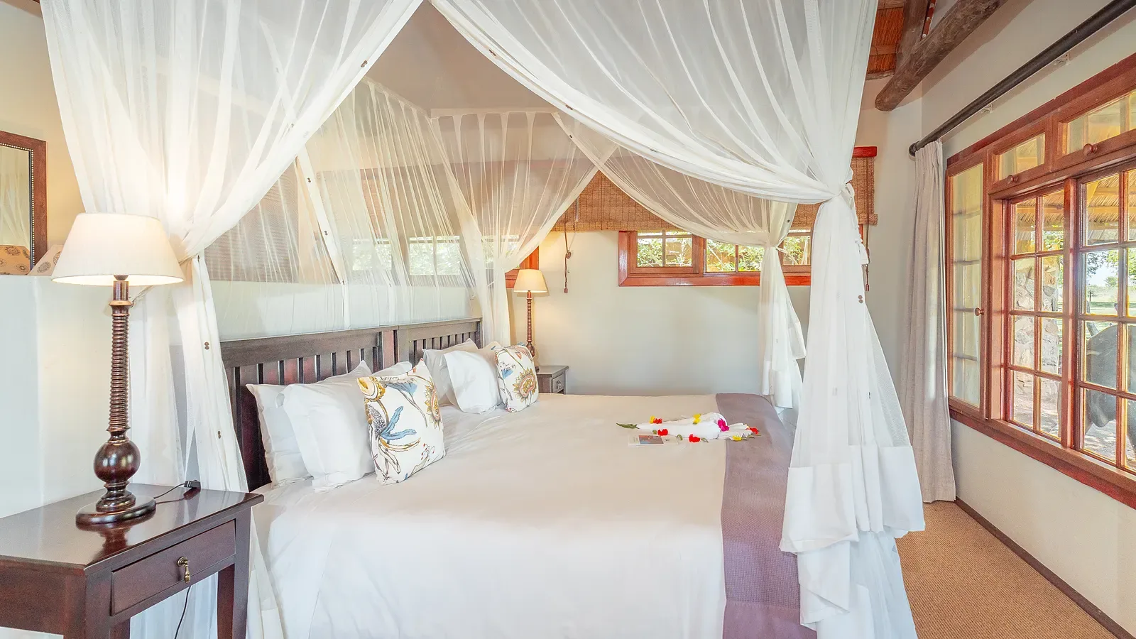 Inside a Nzumba chalet — thatched ceiling and refined safari decor