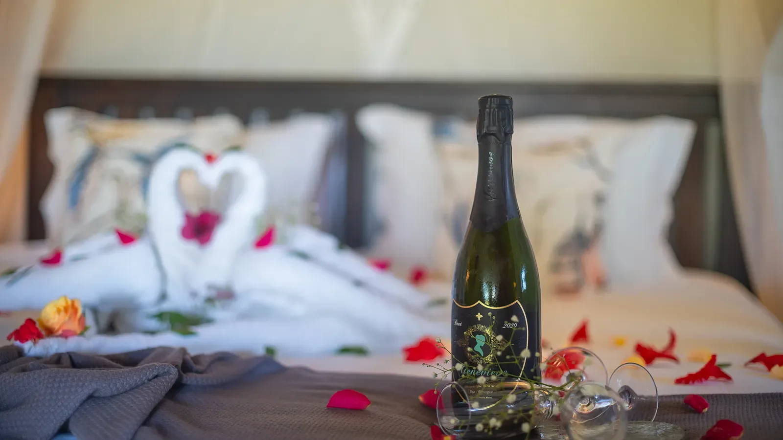 A romantic turn-down at a Nzumba chalet — folded linen and petals