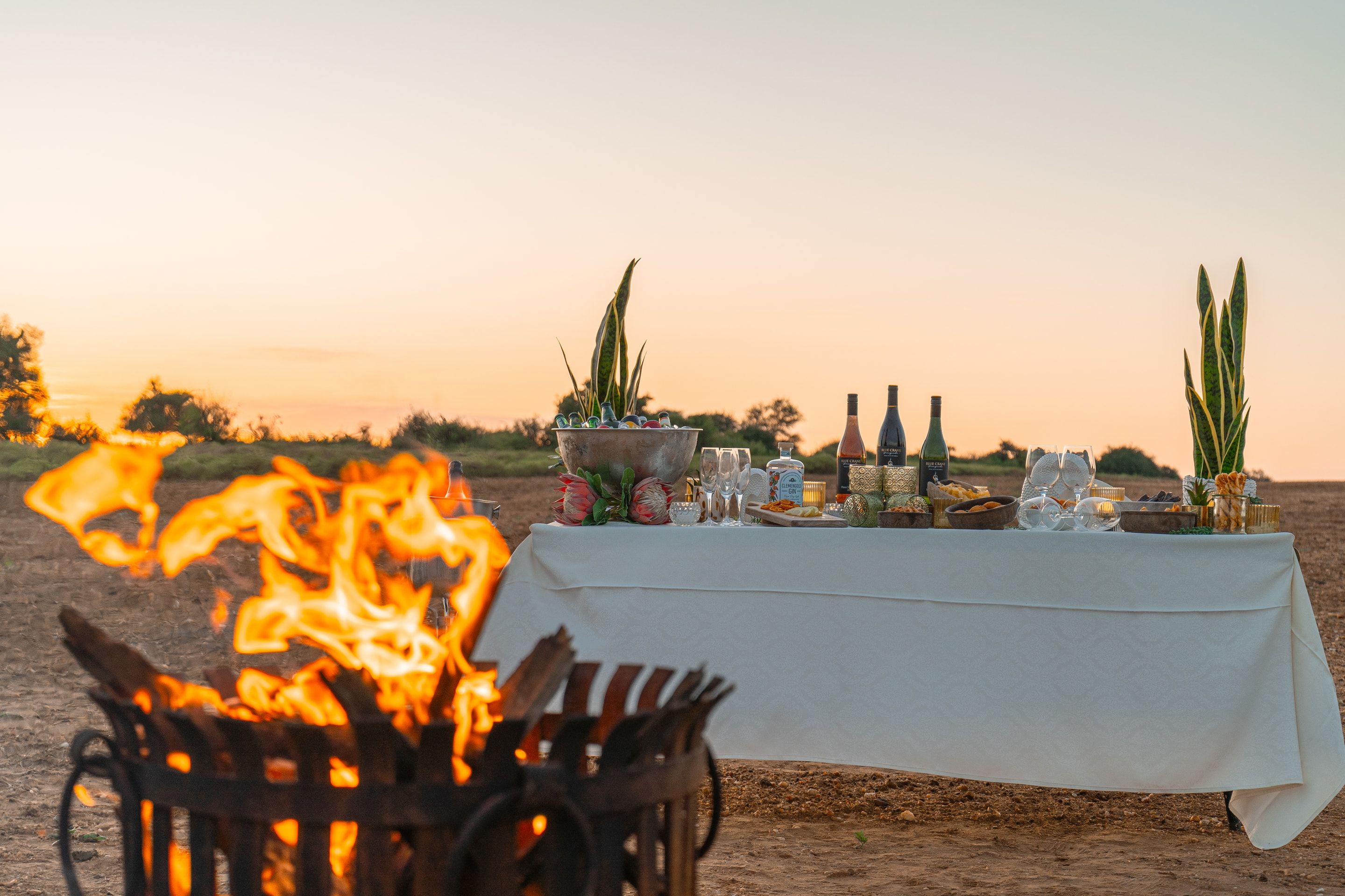 Sundowner drinks spread at Nzumba airstrip against a Klaserie sundown sky